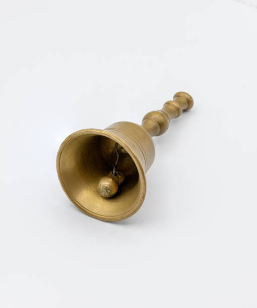istock photograph of a small bronze bell on white 1973539765