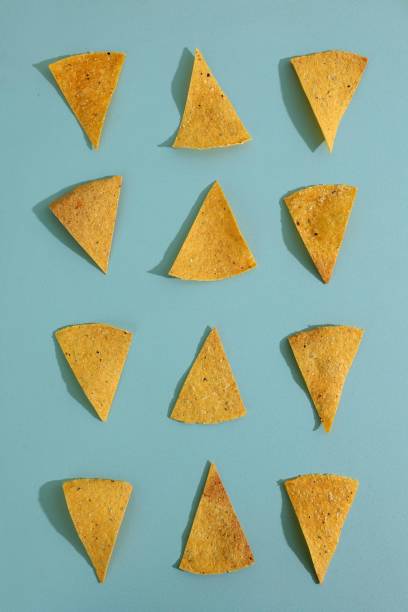 istock Top View Tortilla Nachos Mexican Corn Chips on Mint Background. Delicious Nachos Snack, Flat Lay, Isolated on Mint Table 1973639726