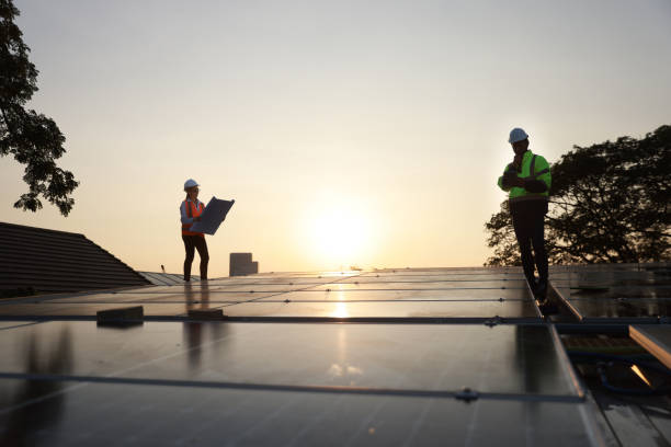 istock Silhouette Site Solar service engineer team working on a solar rooftop against the sunset 1973644374