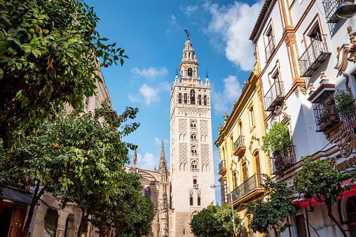 Small square in the neighborhood of Santa Cruz, with the walls of the buildings painted in vivid colors (Seville, Spain)