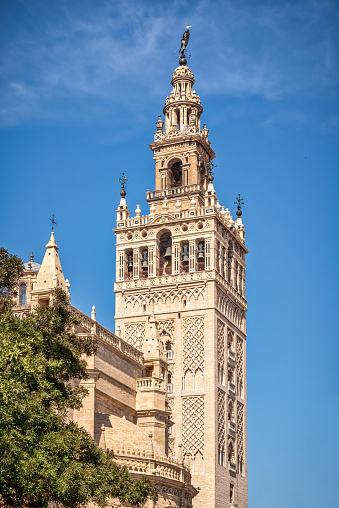 The Giralda is the bell tower of the Cathedral of Seville in Seville, Spain, one of the largest churches in the world and an outstanding example of the Gothic and Baroque architectural styles