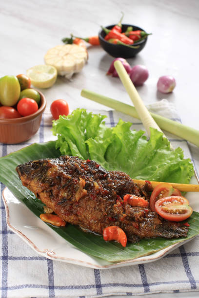 istock Pesmol Fish Using Goldfish. Add Fried Fish to the Pan. Pesmol Typically Fish Recipe from West Java, Indonesia, with Sweet, Sour, and Spicy Taste 1973692462