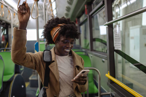 istock Female commuter using smart phone in bus 1973693502