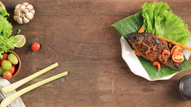 istock Pesmol Fish Using Goldfish. Add Fried Fish to the Pan. Pesmol Typically Fish Recipe from West Java, Indonesia, with Sweet, Sour, and Spicy Taste 1973695538