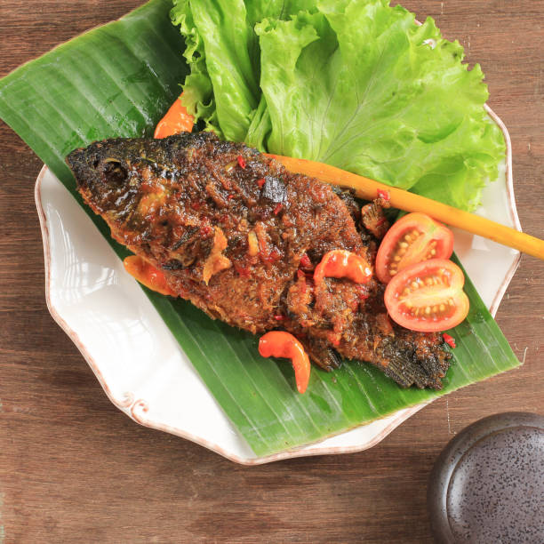 istock Pesmol Fish Using Goldfish. Add Fried Fish to the Pan. Pesmol Typically Fish Recipe from West Java, Indonesia, with Sweet, Sour, and Spicy Taste 1973695540