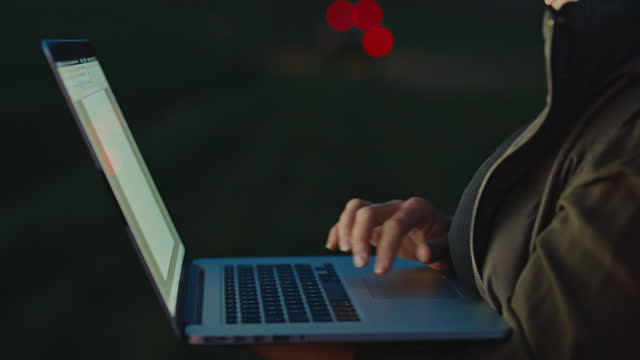 SLO MO Woman typing while Working on Laptop during Dusk