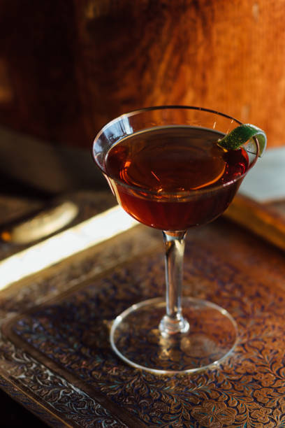 istock whiskey cocktail in coupe with lime garnish 1973708886