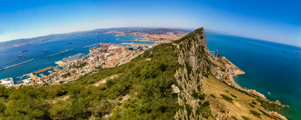 Panoramic view from the top of Gibraltar Rock From Gibraltar Naturel Reserve (Upper Rock), we can see the United Kingdom territory and port on the left, La Línea de la Concepción in Spain in the middle and the Mediterranean Sea on the right. rock of gibraltar photos stock pictures, royalty-free photos & images