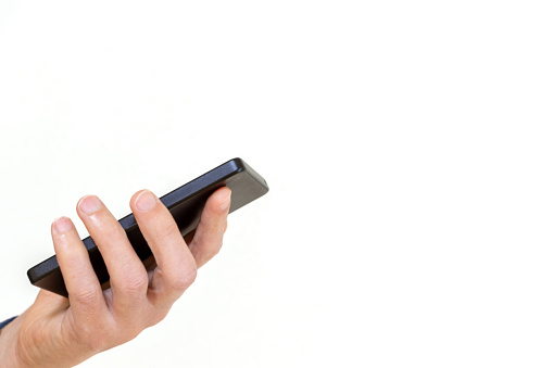 A person's hand holding a smartphone