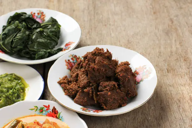 Photo of Selected Focus Rendang or Randang is The Most Delicious Food in the World. Made from Beef Stew and Coconut Milk with Various Herbs and Sice. Typically food from Minang Tribe, West Sumatera, Indonesia