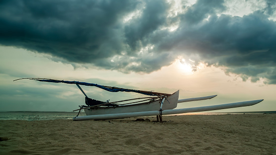 Fisihing boat with sea and beach in the sunset background