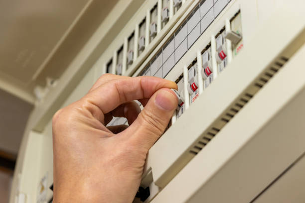 istock Pinch the breaker switch on the distribution board with fingers 1973791607