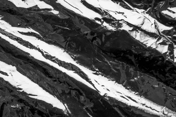istock Black transparent plastic film wrap overlay texture background 1973835964
