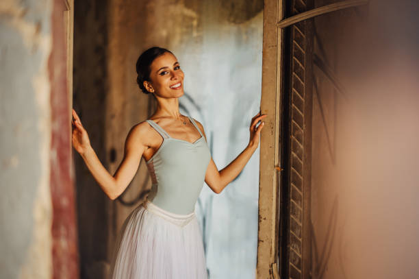 Ballerina. Young graceful woman ballet dancer, dressed in classic, white Chopin tutu, and professional ballet shoes  is demonstrating dancing skill. Beauty of classic ballet.