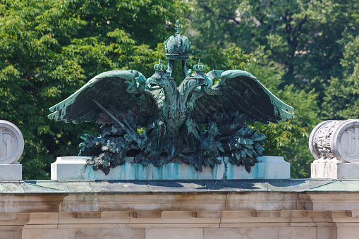 Vienna, Austria. June, 20 - 2013: Burggarten, a bronze sculpture of the double headed eagle, coat of arms of the Hasburgs dinasty Vienna, Austria.