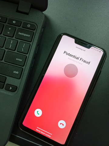 A potential fraud call was detected on a smartphone. The smartphone system detects potential fraud and blocks it automatically by the phone's security system