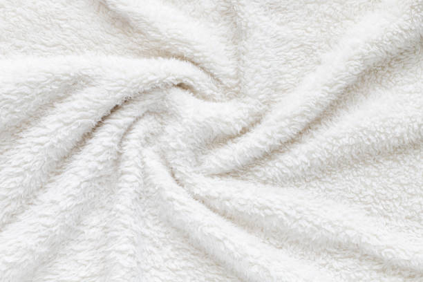 istock White soft plush fabric of cozy plush throw. Cozy blanket. 1973885501