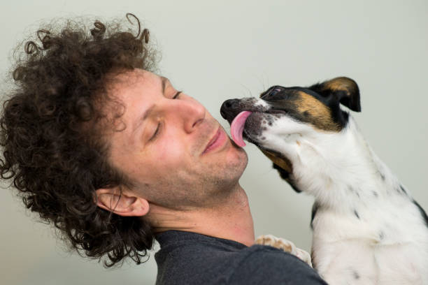 istock Dog Licking Owner After Finally Adopted 1973885510
