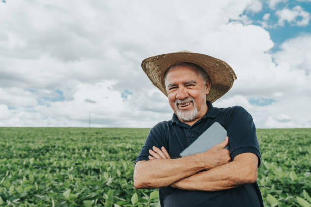 istock Smiling farmer at soybean plantation 1973903208
