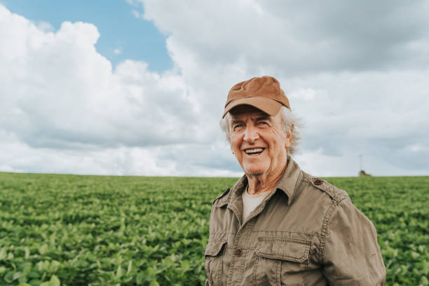 istock Smiling farmer on large soybean plantation 1973903309