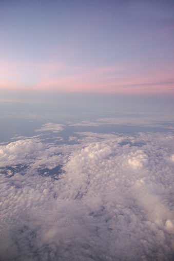 Nature background of sky view with clounds from above from airplane.