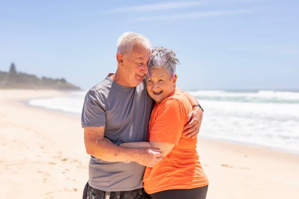istock Active Senior Couple Hugging at the Beach in Summer 1973962449