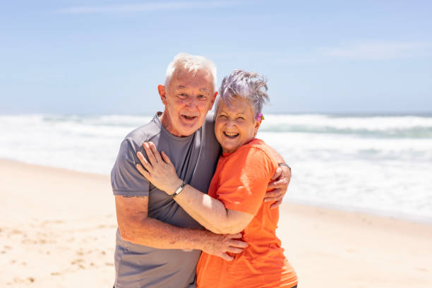 istock Active Senior Couple Hugging at the Beach in Summer 1973962820