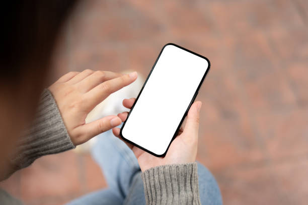 istock A close-up image of a woman using her smartphone while sitting outdoors. a smartphone mockup. 1973995364