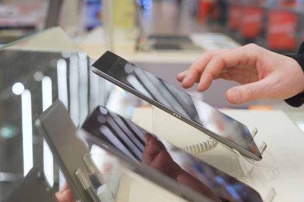 istock A white man uses a digital tablet in an electronics store. 1974018795