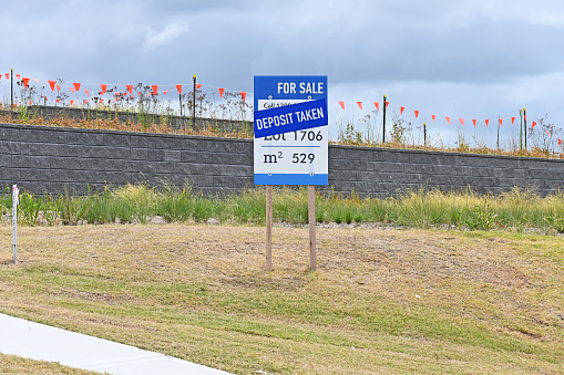 Land for sale sign with a deposit taken