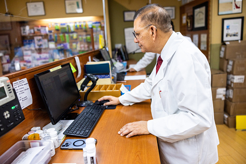 Customers and pharmacists interact inside a pharmacy
