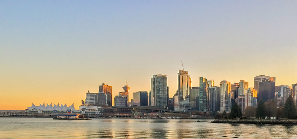 Vancouver, British Columbia, Canada. Nov 15, 2023. A sweeping panorama captures Downtown Vancouver bathed in the warm hues of a winter sunset.