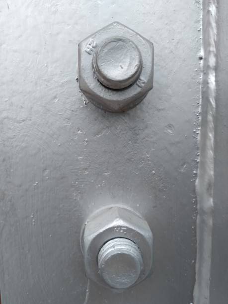 istock metal background with two screws with nuts in front 1974044800
