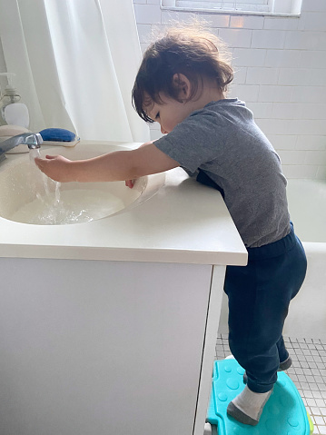 View of a child washing hands in the bathroom
