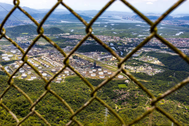 View Through Fence of the Petrochemical Complex in Cubatão, Brazil. Cubatao, Sao Paulo, Brazil - November 20, 2022: View Through Fence of the Petrochemical Complex in Cubatão, Brazil. cubatão stock pictures, royalty-free photos & images