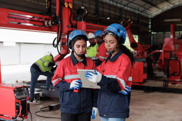 istock Engineer woman talking and discussion about robot arms technology intelligence and innovation while looking digital tablet at factory, people meeting and check machine robot, industry 1974170904