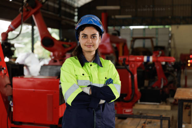 istock Portrait of female industrial engineer  working with robotic technology machine. 1974171938
