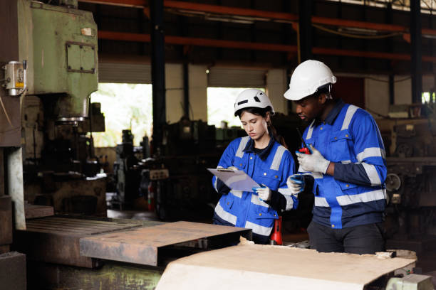 istock Engineer checking machine maintenance service with team working together teamwork in steel heavy factory 1974172471