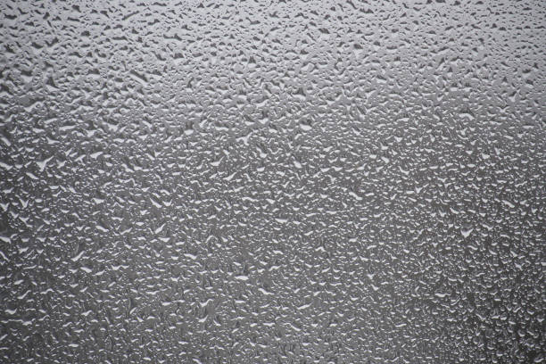 A close-up shot of water droplets on a glass surface