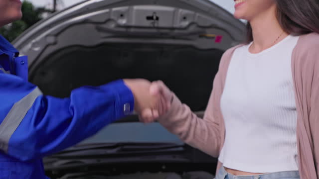 Insurance agent handshake to women customer. Car Insurance claims process.