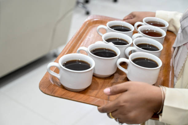 Waiter holding tray and coffee in cafe