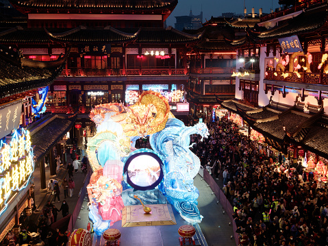 Shanghai, China - Jan. 29, 2024: Lantern Festival in the Chinese New Year( Dragon year), traditional colorful dragon lantern in Yuyuan Garden, crowded tourists enjoy their holiday, high angle view.