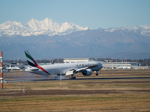 Varese, Italy. Boeing 777 Emirates aircraft is Landing at MXP Milano Malpensa international airport. Emirates Airlines