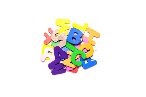 Close-Up Of Alphabets In Box Over White Background