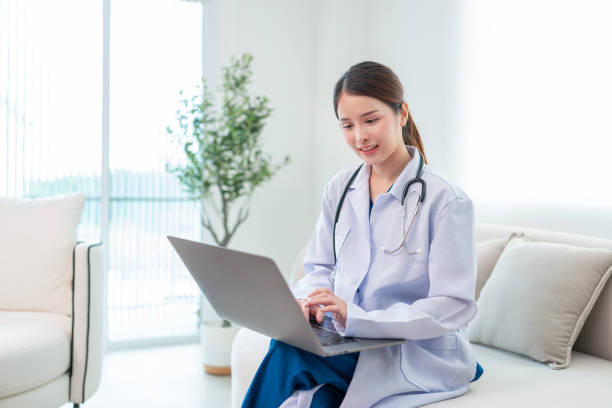 istock Female Doctor  Using laptop in Hospital Corridor. 1974305585