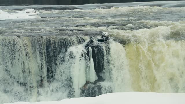 A 4K panning Shot of environment nature Tourism Travel Landmark frozen winter Pisew Kwasitchewan Falls Waterfall Provincial Park near Thompson Manitoba Northern Arctic Canada Landscape