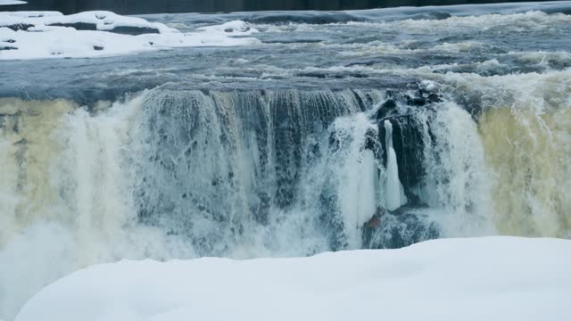 A Slow 4K Zoom Shot of environment nature Tourism Travel Landmark frozen winter Pisew Kwasitchewan Falls Waterfall Provincial Park near Thompson Manitoba Northern Arctic Canada Landscape