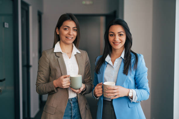 istock Two young colleagues chatting in office hallway 1974322097