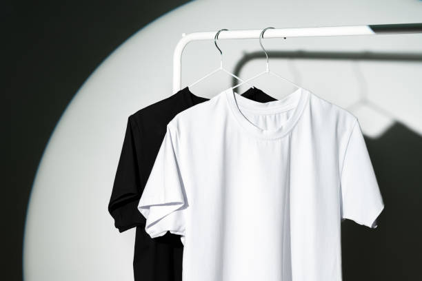istock Blank T-shirt hanging in a spotlight in studio 1974345519
