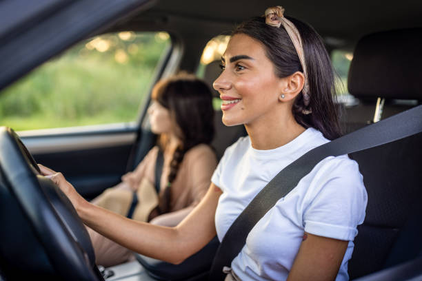 istock Mother and daughter travelling by a car 1974382935